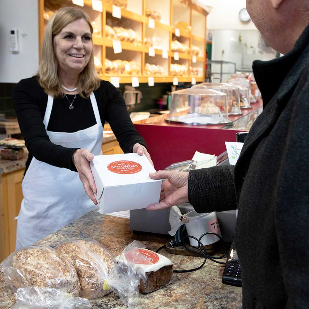 worker handing product to customer